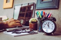 Desk with laptop and clock