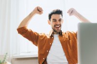 Man with arms upraised in sign of success