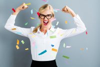 Strong professional woman with confetti floating around her