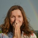 Woman standing in front of a rainbow, good fortune