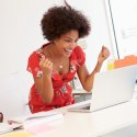 Woman cheering at laptop