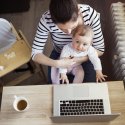 Mother with young child at laptop