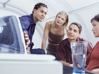 Group of people around a computer