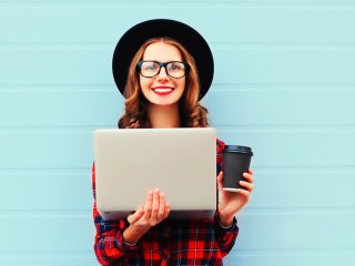 A happy woman on her laptop