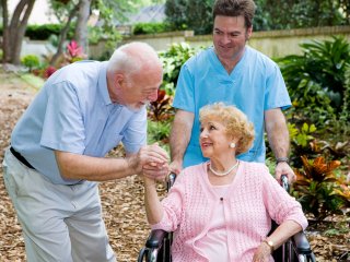 Caregiver with older couple out in nature