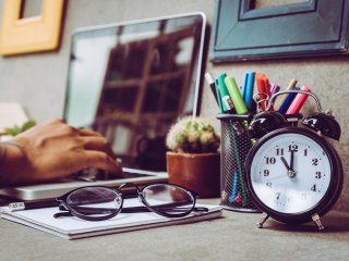 Desk with laptop and clock