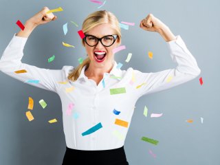 Strong professional woman with confetti floating around her